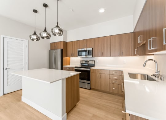 a white kitchen with wooden cabinets and stainless steel appliances