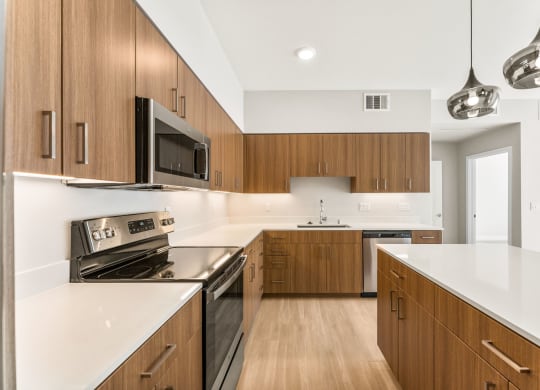 a large kitchen with wooden cabinets and white counter tops
