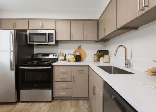 a kitchen with stainless steel appliances and white counter tops