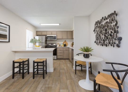 an open kitchen and living room with a table and chairs