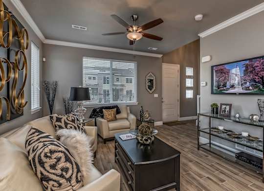 A living room with a white couch and a black coffee table.