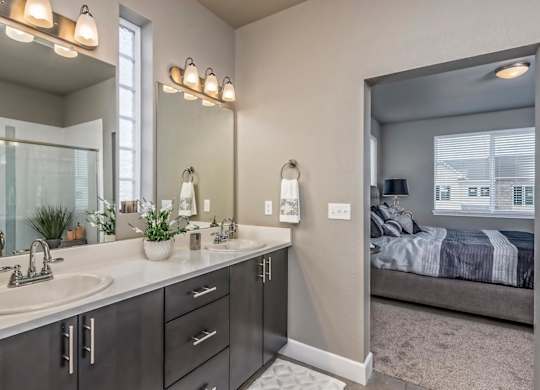 A bathroom with a double sink and a large mirror.