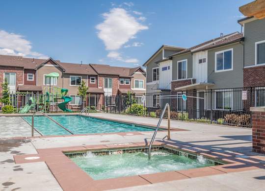 A small pool with a slide in a residential area.