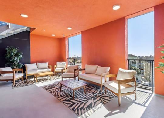 A living room with orange walls and furniture.