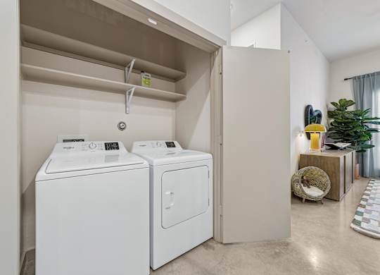 A laundry room with a washer and dryer in it.
