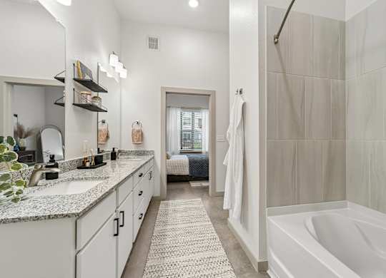 A bathroom with a white tub and a shower.