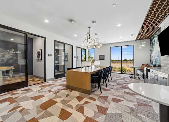 A modern kitchen with a tiled floor and a dining table set up.