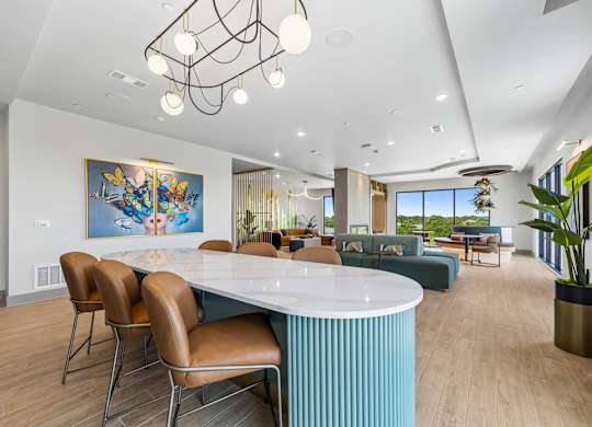 A modern dining room with a large table and chairs.