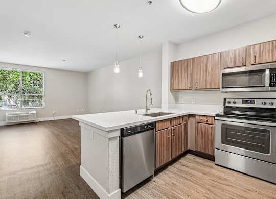 A kitchen with wooden cabinets and stainless steel appliances.