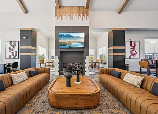 A modern living room with a fireplace and a large screen TV.