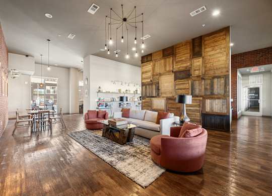 A modern living room with a wooden floor and a large sectional sofa.