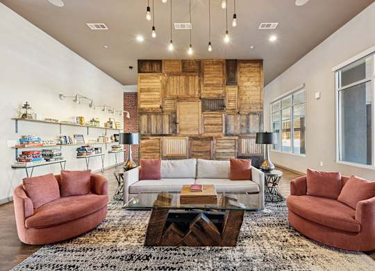 A living room with a white couch, a red chair, and a coffee table.