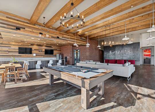 A room with a long wooden table and chairs.