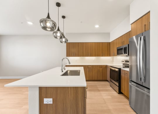 a kitchen with wooden cabinets and stainless steel appliances