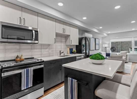 A modern kitchen with a black oven and a white countertop.