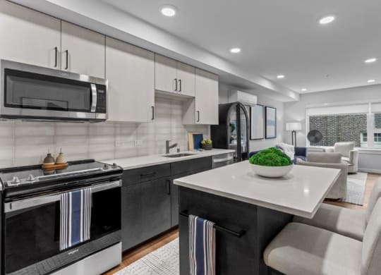 a kitchen and living room with a table and chairs