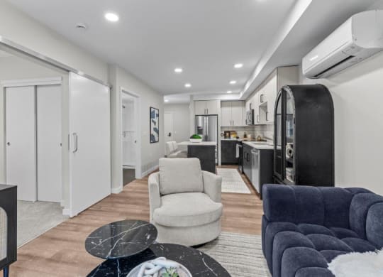 a living room with a kitchen and a couch