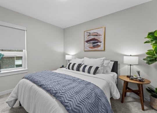 a bedroom with a large bed and a window