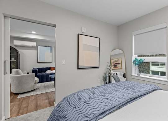 A bedroom with a large bed and a mirror on the wall.