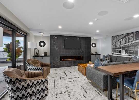 A modern living room with a fireplace and a television.