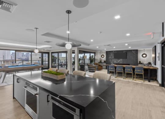 a large kitchen with an island and a pool table