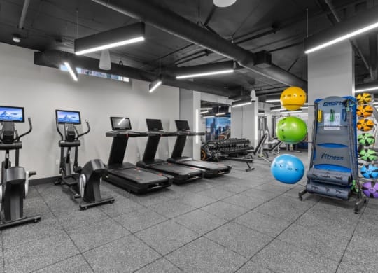 a gym with cardio equipment and weights in a building