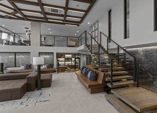 A modern living room with a staircase and a couch.
