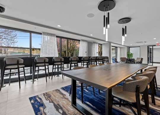 A conference room with a long table and chairs.