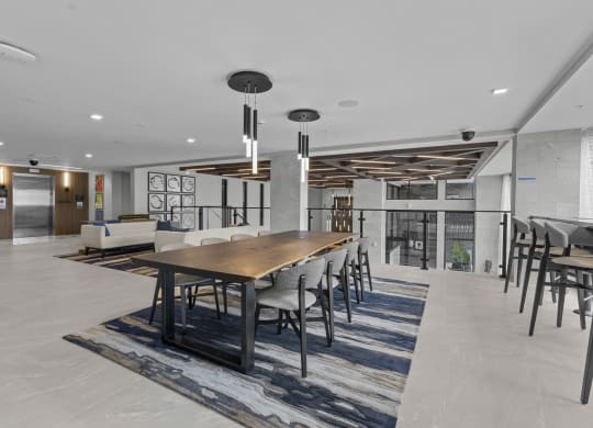 a large dining room with a long wooden table and chairs