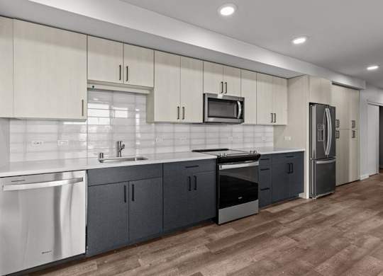 A modern kitchen with dark wood floors and white appliances.