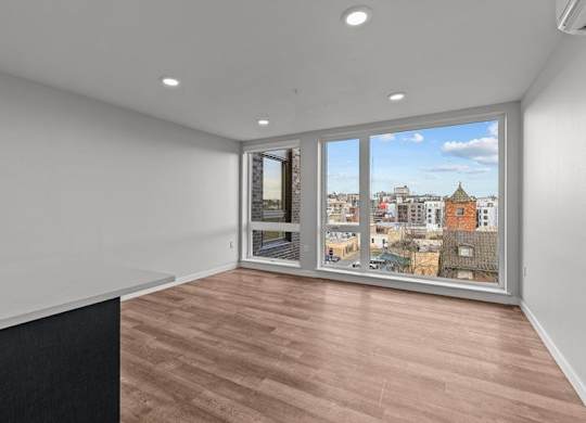 A room with a large window overlooking a cityscape.