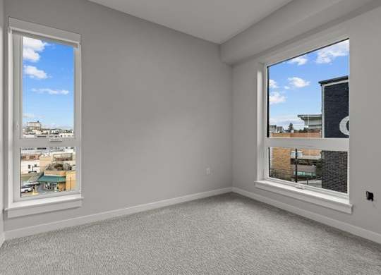 A room with a large window overlooking a cityscape.