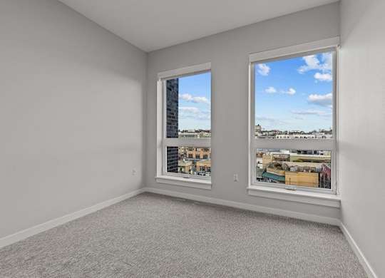 A room with a window overlooking a cityscape.