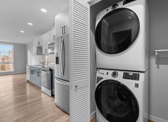 a washer and dryer in a laundry room next to a kitchen