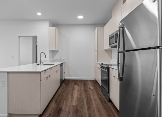 a renovated kitchen with white cabinets and stainless steel appliances