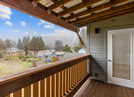 the view from the deck of a home with a white door and a porch