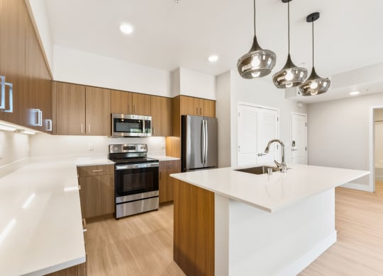 a white kitchen with wooden cabinets and stainless steel appliances