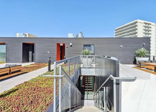 A modern building with a metal staircase leading to the entrance.