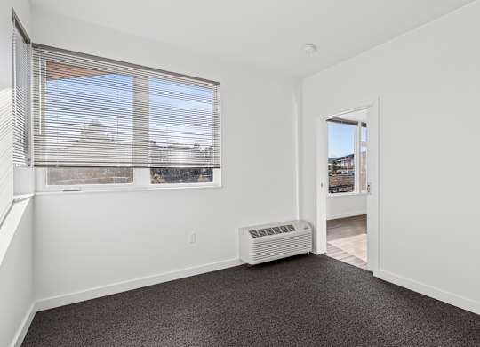 A room with a window and a door.