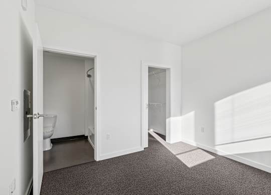 A white bathroom with a toilet and sink.