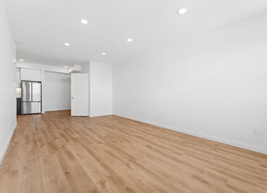 OnyxOnPark_SanDiego_CA_Vacant_2BR_ A room with wooden floors and white walls.