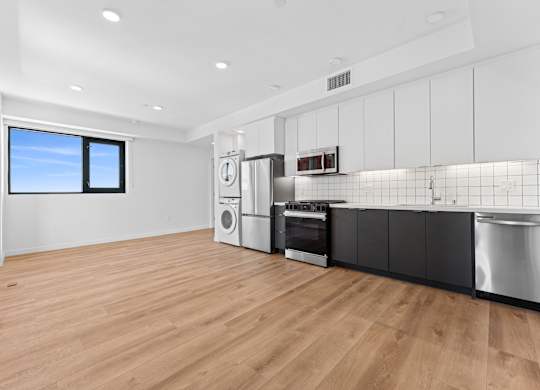 OnyxOnPark_SanDiego_CA_Vacant_2BR_B1_A kitchen with a washer and dryer built in.