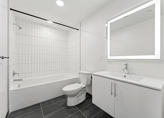 OnyxOnPark_SanDiego_CA_Vacant_2BR_B1_A white bathroom with a toilet, sink, and bathtub.