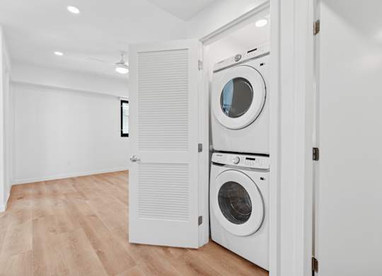 OnyxOnPark_SanDiego_CA_Vacant_Penthouse_A_A white laundry room with two washing machines.