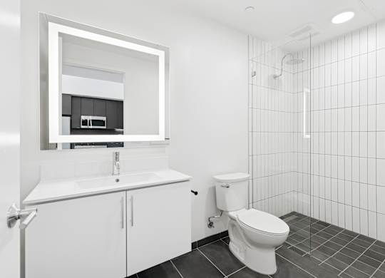OnyxOnPark_SanDiego_CA_Vacant_Penthouse_A_OnyxOnPark_SanDiego_CA_Vacant_Penthouse_A_A white bathroom with a toilet, sink, and mirror.