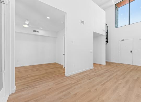 OnyxOnPark_SanDiego_CA_Vacant_Penthouse_A_OnyxOnPark_SanDiego_CA_Vacant_Penthouse_A_A room with wooden floors and white walls.
