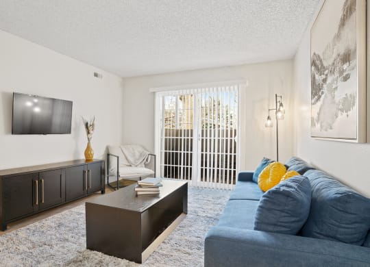 a living room with a blue couch and a tv