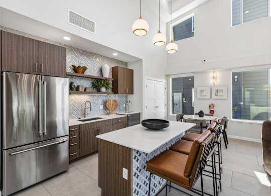 A modern kitchen with a large island and stainless steel appliances.