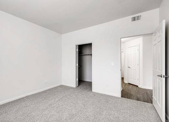 A room with a white door and a white wall.