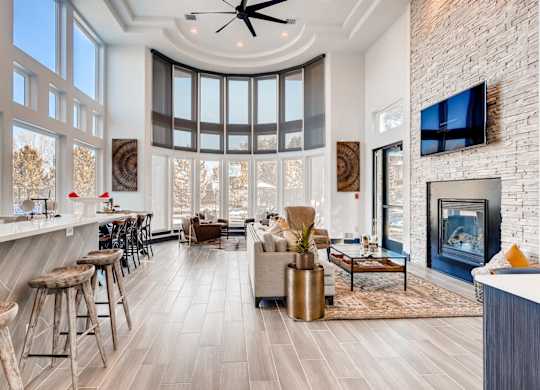 A modern living room with a fireplace and a bar area.